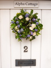 white wooden retro door with flowers ivy leaves cottage special home