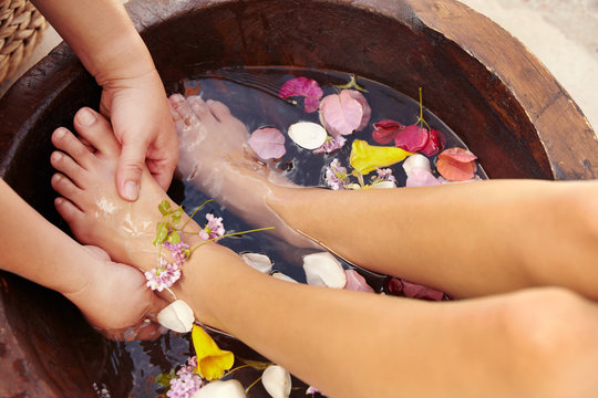 Hispanic woman receiving a foot massage and pedicure at luxury spa