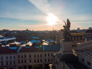 statue on roof of old european building on sunset