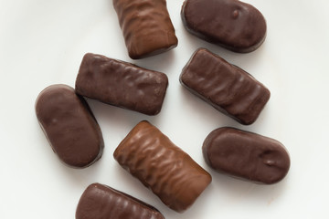 Assortment of chocolate candies sweets on white background, top view