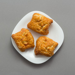 Freshly baked butter croissant grey background, top view