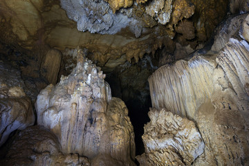 Stalactites and stalagmites at the dark Tham Loup Cave near Vang Vieng, Vientiane Province, Laos.