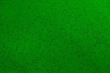 Trendy dark green abstract background with small black chaotically scattered lint