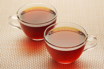 Two glass cups with black tea