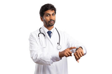 Doctor pointing at watch with serious expression.