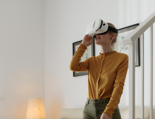 Charming girl in glasses enjoying virtual reality
