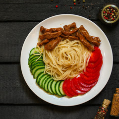 Fettuccine spaghetti pasta with tomatoes and herbs. Top view