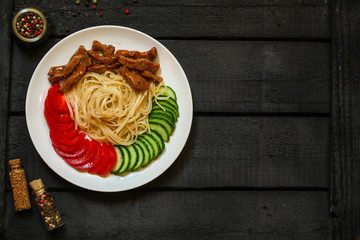 Fettuccine spaghetti pasta with tomatoes and herbs. Top view