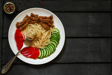 Fettuccine spaghetti pasta with tomatoes and herbs. Top view