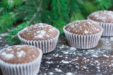 Christmas cakes on winter snowbound wooden background, fir tree