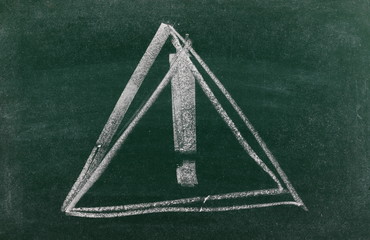 Danger triangular road, traffic sign with exclamation mark drawn on chalkboard, blackboard...