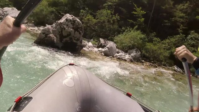 Adventure POV shot of front of rafting boat in Soca river in Slovenia.