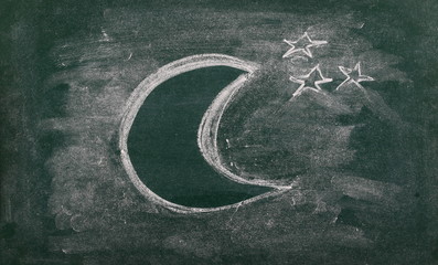 Half moon and stars drawn on chalkboard, blackboard background, texture
