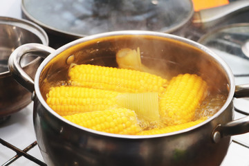 Yellow corn stew in a saucepan. Flavored dinner