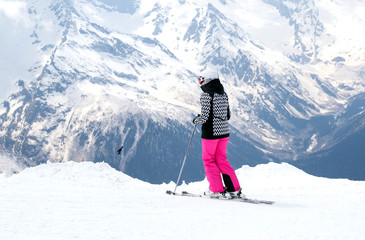 skier in mountain skiing equipment in the Caucasus mountains, ski resort in winter