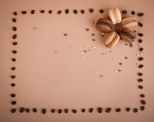 Deliious juicy makaroner, on beige color cappuccino background.