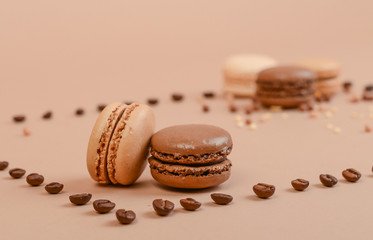 Deliious juicy makaroner, on beige color cappuccino background.