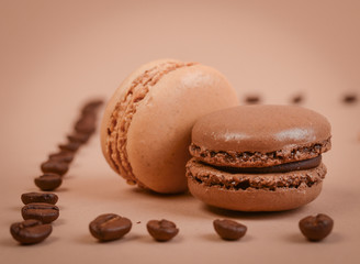 Deliious juicy makaroner, on beige color cappuccino background.