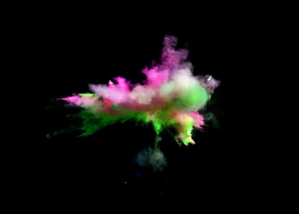 Multi Colored forms of powder paint and flour combined  together explode in front of a black background to give off fantastic  multi colored explosions.