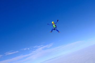 Naklejka na ściany i meble Sport girl is flying in the sky.