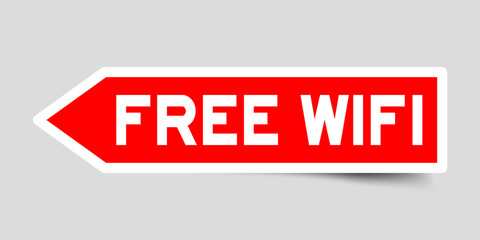 Sticker in red color arrow shape with word free wifi on gray background