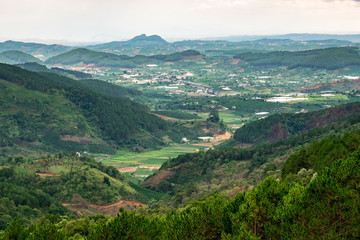 Naklejka na ściany i meble Panoramic view of mountains and valleys in Dalat, Vietnam. Da lat is one of the best tourism cities and aslo one of the largest vegetable and flowers growing areas in Vietnam
