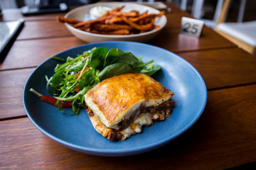 Meat Lasagna with fresh salad, sweet potato chips
