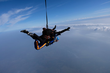 Skydiving. Tandem jump for emotional pretty girl.