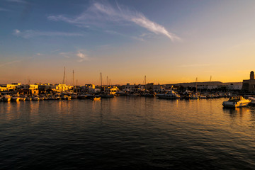 Fototapeta na wymiar Sunset in Villanova port harbour Marina Ostuni on the Adriatic sea