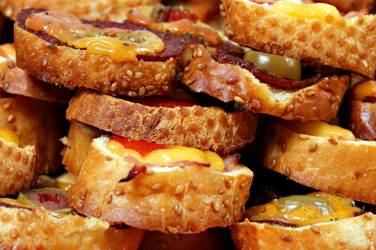 delicious bruschetti with cheese olives and salami italian food background