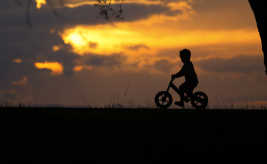 Obraz na płótnie Canvas Shadow Boy Balancing play fast, fun bike in the park.