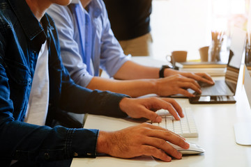 Fototapeta premium A man coworker with computer and typing with computer keyboard.