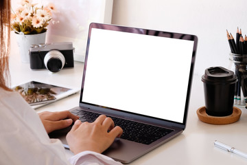 Female woman using mockup laptop computer on office desk, empty display computer.