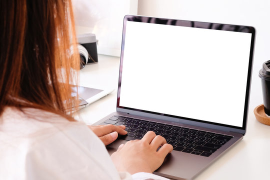 Female Woman Using Mockup Laptop Computer On Office Desk, Empty Display Computer.