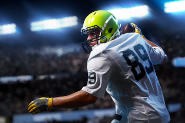 Fototapeta premium American football sportsman player on stadium in action. Sport advertising