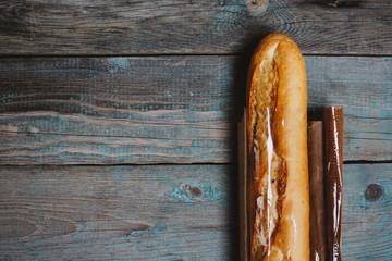 Fresh bread baguette on wooden table. Top view with space for your text