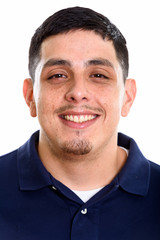 Obraz premium Face of young happy Hispanic man smiling 