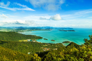 View of tropical island Langkawi in Malaysia, covered with tropical forests. Aerial view on the bay, marina and archipelago of smaller islands in Andaman sea. - obrazy, fototapety, plakaty