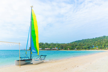 Sailboat on sand beach and sky