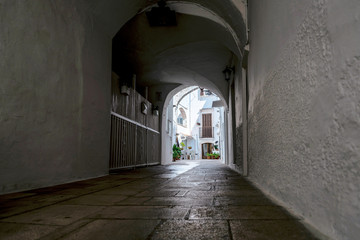 Little alley in the medieval center of the white village of Locorotondo
