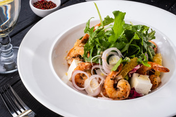 Fresh Sicilian Salad with shrimps, arugula, cheese and ripe orange slices.