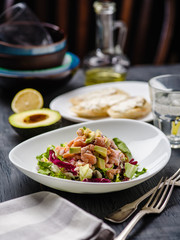 Ceviche is a traditional dish from Peru. Salmon marinated in lemon with fresh lettuce, avocado and onions
