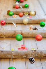 Christmas ball and snowflakes hanging on wooden background.
