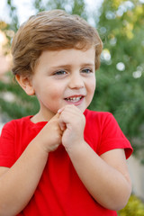 Happy child with red t-shirt in the garden