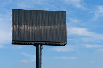 Blank black billboard with copy space for advertisement text image with blue sky cloud. vintage...