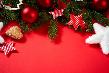 beautiful Christmas baubles, twigs of spruce, stars on a red background