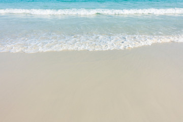 Fototapeta na wymiar Soft blue ocean wave on sandy beach