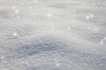 Artistic sunny snowy field floor details with sparkles. New Year greeting card copy space background. Selective focus used.