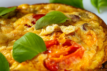 Breakfast food - Omelette with pork sausages, cheese, onion and cherry tomatoes