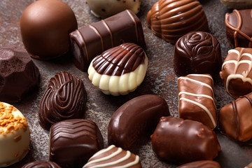 Different type of chocolate candies on a dark background
